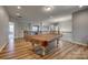 Open game room with a pool table and hardwood floors, offering a spacious entertainment area at 14925 Baldridge Dr, Huntersville, NC 28078