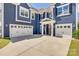Three-car garage with white doors and ample driveway space for parking at 14925 Baldridge Dr, Huntersville, NC 28078