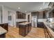 Open kitchen with an island, stainless steel appliances, granite countertops, and wood flooring at 14925 Baldridge Dr, Huntersville, NC 28078