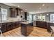 Bright kitchen with dark cabinetry, granite countertops, stainless steel appliances, and ample counter space at 14925 Baldridge Dr, Huntersville, NC 28078