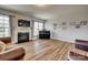 Cozy living room with fireplace, wood floors, and comfortable seating at 14925 Baldridge Dr, Huntersville, NC 28078