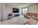 Inviting living room featuring a large window, a comfortable recliner, and a wall-mounted TV at 14925 Baldridge Dr, Huntersville, NC 28078