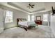 Spacious main bedroom with tray ceilings, multiple windows, and plush carpeting at 14925 Baldridge Dr, Huntersville, NC 28078