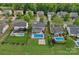 Aerial view of a home with a backyard pool, a covered patio, surrounded by mature trees in a neighborhood at 156 Pecan Hills Dr, Mooresville, NC 28115