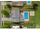 Aerial view of a home featuring a backyard pool, landscaping, and privacy fence in a suburban neighborhood at 156 Pecan Hills Dr, Mooresville, NC 28115