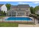 Large backyard featuring an in-ground pool, a covered patio, providing a private and serene outdoor space at 156 Pecan Hills Dr, Mooresville, NC 28115