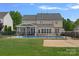 Expansive backyard showcasing an in-ground pool, a covered patio, well-manicured lawn, and privacy fencing at 156 Pecan Hills Dr, Mooresville, NC 28115