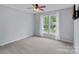 This carpeted bedroom has two windows, neutral paint and a ceiling fan at 156 Pecan Hills Dr, Mooresville, NC 28115