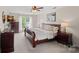 This primary bedroom features a ceiling fan, neutral walls, carpet and furniture at 156 Pecan Hills Dr, Mooresville, NC 28115