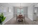 Inviting dining area with a wood table, chandelier, and large window overlooking the backyard at 156 Pecan Hills Dr, Mooresville, NC 28115