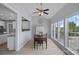 Bright dining room features a ceiling fan, modern lighting, and views of the backyard at 156 Pecan Hills Dr, Mooresville, NC 28115