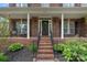 Charming brick home featuring a welcoming front porch with decorative columns and a well-manicured garden at 156 Pecan Hills Dr, Mooresville, NC 28115