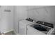 Well-lit laundry room features modern appliances and shelving at 156 Pecan Hills Dr, Mooresville, NC 28115