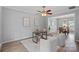 Cozy living room area with a fan, a modern desk, and entry to dining room at 156 Pecan Hills Dr, Mooresville, NC 28115