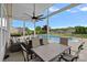 Inviting covered patio featuring a dining set and cozy seating area overlooking the sparkling backyard pool at 156 Pecan Hills Dr, Mooresville, NC 28115