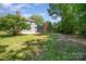 Spacious backyard with lush green lawn and mature trees, perfect for outdoor entertaining and recreation at 1640 English Knoll Dr, Matthews, NC 28105