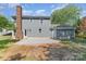 This backyard has a newly graveled area, a brick chimney, and grassy areas at 1640 English Knoll Dr, Matthews, NC 28105
