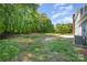 Large, grassy backyard with mature trees, offering privacy and a sense of nature at 1640 English Knoll Dr, Matthews, NC 28105