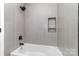 Clean bathroom features modern shower head, bathtub and tile backsplash at 1640 English Knoll Dr, Matthews, NC 28105