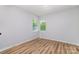 Well-lit bedroom featuring two windows and wood flooring at 1640 English Knoll Dr, Matthews, NC 28105