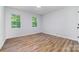 Spacious bedroom featuring two large windows, ample natural light and wood floors at 1640 English Knoll Dr, Matthews, NC 28105