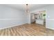 Open concept dining room with wood floors leading to the kitchen at 1640 English Knoll Dr, Matthews, NC 28105