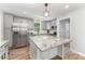 Modern kitchen features stainless steel appliances, granite countertops, and a large island at 1640 English Knoll Dr, Matthews, NC 28105