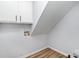 This laundry room features wood-look floors and white cabinets above the washer and dryer hookups at 1640 English Knoll Dr, Matthews, NC 28105