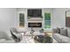 Bright living room featuring a sleek fireplace, modern furniture, and natural light from the exterior door and window at 1640 English Knoll Dr, Matthews, NC 28105