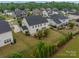 Aerial view of a landscaped backyard and neighborhood showcases a well-maintained property at 16711 Monocacy Blvd, Huntersville, NC 28078