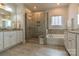 Bathroom features a glass-enclosed shower, a soaking tub, double sinks, and tiled floors at 16711 Monocacy Blvd, Huntersville, NC 28078