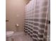 Simple bathroom featuring a toilet, neutral colored shower curtain, and neutral colored walls at 16711 Monocacy Blvd, Huntersville, NC 28078