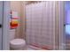 Simple bathroom with a shower-tub combination featuring white tiles and a neutral colored shower curtain at 16711 Monocacy Blvd, Huntersville, NC 28078