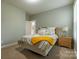 Cozy bedroom with neutral tones, a comfortable bed, and a door leading to a small balcony at 16711 Monocacy Blvd, Huntersville, NC 28078