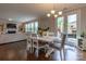 Open dining room features a farmhouse table, modern lighting, and access to an outdoor patio at 16711 Monocacy Blvd, Huntersville, NC 28078