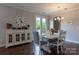 Charming dining room features a farmhouse table, decorative chandelier, and access to outdoor space at 16711 Monocacy Blvd, Huntersville, NC 28078