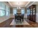 A dining room featuring hardwood floors, modern trim, and a classic china cabinet at 16711 Monocacy Blvd, Huntersville, NC 28078
