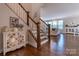 Inviting foyer features wood floors, a staircase, and natural light from the living room at 16711 Monocacy Blvd, Huntersville, NC 28078