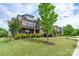A well-maintained lawn and neatly trimmed bushes highlight the house's exterior at 16711 Monocacy Blvd, Huntersville, NC 28078