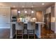 Kitchen island with barstool seating, stainless steel appliances, and pendant lighting above at 16711 Monocacy Blvd, Huntersville, NC 28078