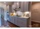 Modern kitchen features grey cabinets, stainless steel appliances, and a white subway tile backsplash at 16711 Monocacy Blvd, Huntersville, NC 28078