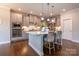 A modern kitchen showcasing a center island, gray cabinets, and stainless-steel appliances at 16711 Monocacy Blvd, Huntersville, NC 28078