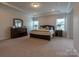 Spacious main bedroom features tray ceilings, ample natural light, and a well-appointed dresser at 16711 Monocacy Blvd, Huntersville, NC 28078
