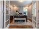 Bright home office featuring a large desk, a bench and french doors leading to the rest of the house at 16711 Monocacy Blvd, Huntersville, NC 28078