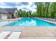 Large community swimming pool surrounded by patio seating and lush greenery at 16711 Monocacy Blvd, Huntersville, NC 28078