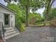 View of the backyard showing the privacy fence and mature trees at 1733 Piccadilly Dr, Charlotte, NC 28211
