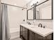 Elegant bathroom featuring a double sink vanity, modern fixtures, and a shower-tub combination at 1733 Piccadilly Dr, Charlotte, NC 28211