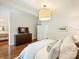 A soothing bedroom features a dark wood dresser, and a lovely hanging lamp at 1733 Piccadilly Dr, Charlotte, NC 28211
