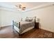 Comfortable bedroom with a ceiling fan, wood floors, a metal frame bed, and a nightstand at 1733 Piccadilly Dr, Charlotte, NC 28211