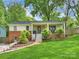 Charming home with brick and painted facade, inviting front porch, and lush lawn and landscaping at 1733 Piccadilly Dr, Charlotte, NC 28211